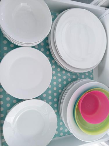 a group of white plates on a shelf at Brand NEW VIP Luxury 5/5 Star Beachside Escape in Sydney