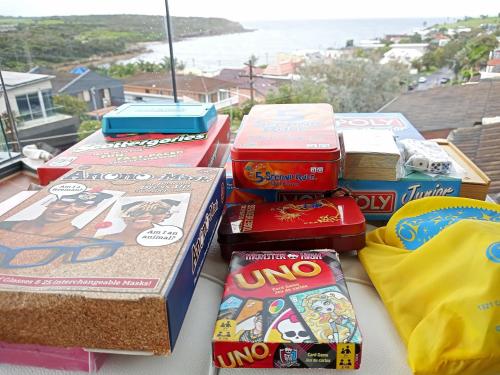 a pile of boxes sitting on top of a table at Brand NEW VIP Luxury 5/5 Star Beachside Escape in Sydney