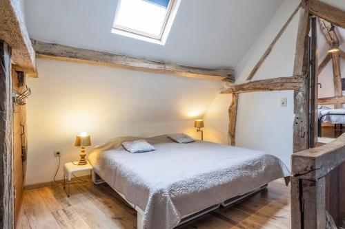 ein Schlafzimmer mit einem Bett und einem Dachfenster in der Unterkunft Lovely apartment in Voeren in Voeren