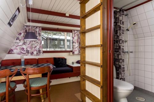Habitación pequeña con mesa, sofá y aseo en Hallingparken en Gol