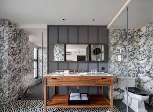 a bathroom with a sink and a mirror at Hotel Kapok Shenzhen HouHai (Close to Shenzhen Bay) in Shenzhen