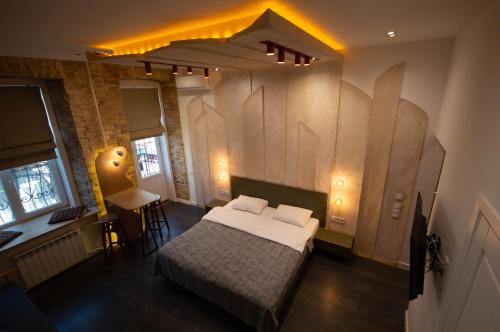 a bedroom with a bed and a table and chairs at Kyiv Volcano Studio in Kyiv