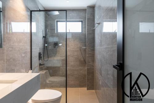 a bathroom with a shower and a toilet and a sink at Kontor Mansion - 3 mins to Teluk Chempedak Beach & Private Pool in Kuantan