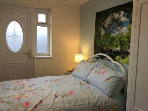 a bedroom with a bed and a window at TDM Bachelot Lettings Ltd in London