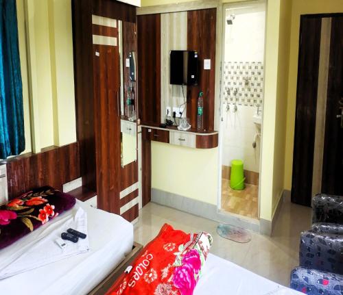 Habitación con cama y baño con ducha. en STAYMAKER Tirupati Guest House, en kolkata