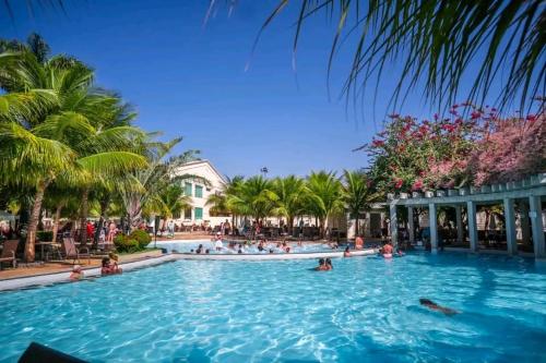 a pool at a resort with people in it at Lacqua DiRoma III com roupa de cama in Caldas Novas