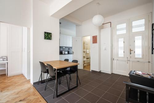 a kitchen and dining room with a table and chairs at Liget Apartment in Budapest