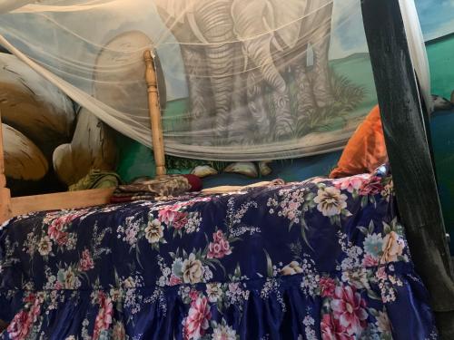 a table with a curtain on top of it at Tortoise park, Ecolodge & Campsite in Lugala