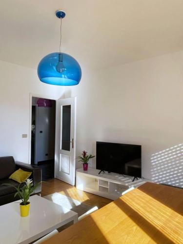 a living room with a couch and a blue light at Olivrea Design Palazzo in Ivrea
