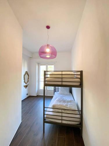 a bedroom with a bunk bed and a pink light at Olivrea Design Palazzo in Ivrea