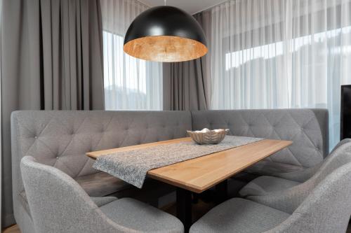 a dining room with a table and a couch at A Casa Elements in Serfaus