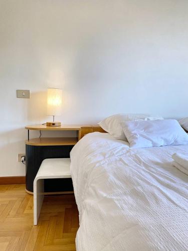 a bedroom with a bed and a desk with a lamp at Olivrea Design Palazzo in Ivrea