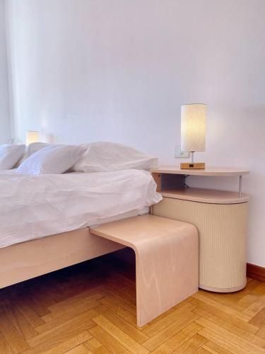 a bedroom with a bed and a table with a lamp at Olivrea Design Palazzo in Ivrea