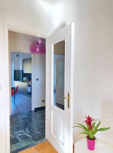 a door leading into a kitchen with a potted plant at Olivrea Design Palazzo in Ivrea