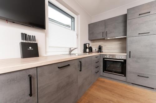 a kitchen with stainless steel appliances and a window at A Casa Elements in Serfaus