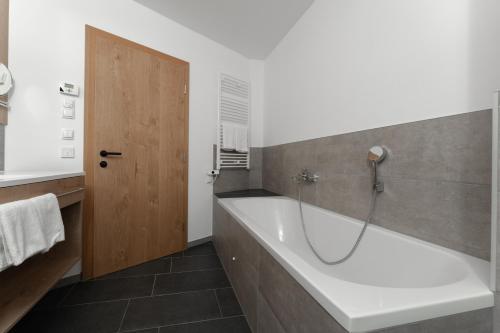 a bathroom with a bath tub and a sink at A Casa Elements in Serfaus