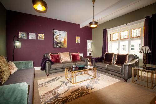 a living room with two couches and a table at WhiteGates Rows City Centre Apartment by Rework Accommodation in Chester