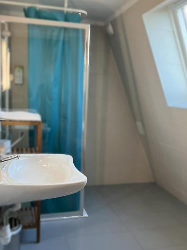 a bathroom with a sink and a shower at Kyriad Argenteuil in Argenteuil