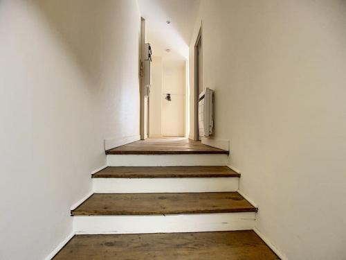 a hallway with stairs and an open door at [L'ABBAT-JOUR] Le Béryl • Plein Sud • Thermes in Bagnères-de-Bigorre