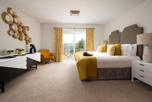 a bedroom with a large bed and a large window at The Sheep Fold in Melrose
