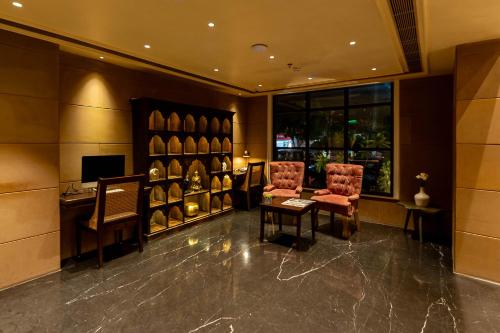 a wine tasting room with two chairs and a desk at Historia Royal in Udaipur