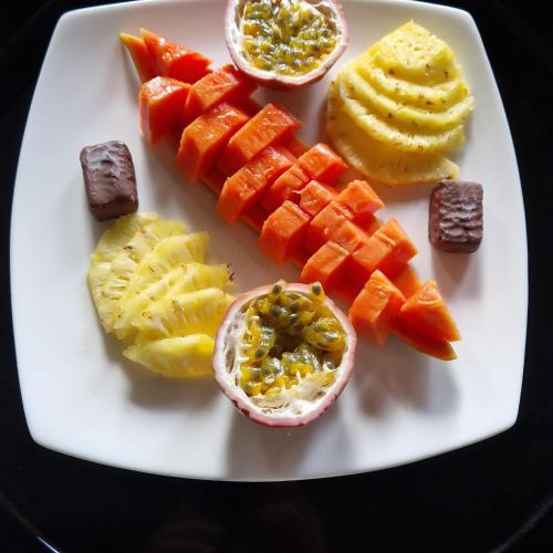 a white plate with different types of fruit on it at MILLET'S FOOD COMPANY AND COOKING CENTER in Negombo