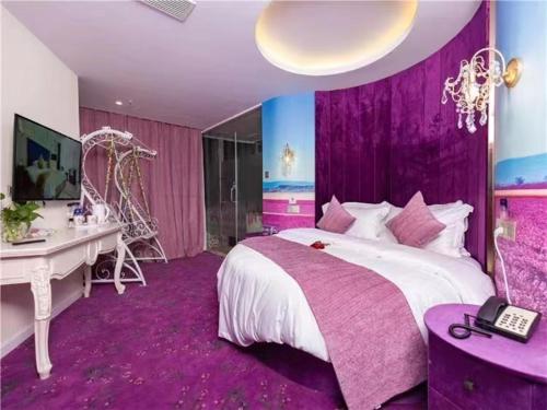 a purple bedroom with a bed and a desk and a computer at Fresh House Hotel - West Lake Qingchun Branch in Hangzhou