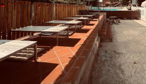 a row of tables and benches on a patio at Vongprachan Backpackers Hostel in Luang Prabang
