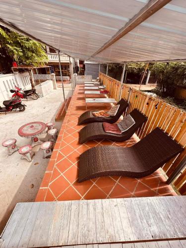 a row of chaise lounges on a patio at Vongprachan Backpackers Hostel in Luang Prabang