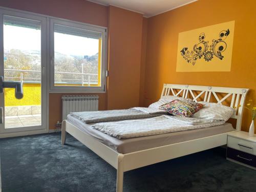 a bedroom with a bed and a window at Amazing Penthouse old town in Sarajevo