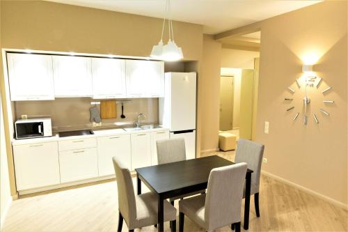 a kitchen and dining room with a table and chairs at MIRAMAR Apart Hotel & SPA in Aktau