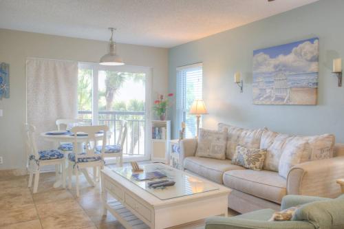 a living room with a couch and a table at 306 - Gulf Strand in St. Pete Beach