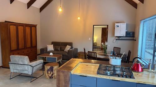 a kitchen and living room with a couch and a table at Dullstroom Selfcatering Blue Crane Estate in Dullstroom