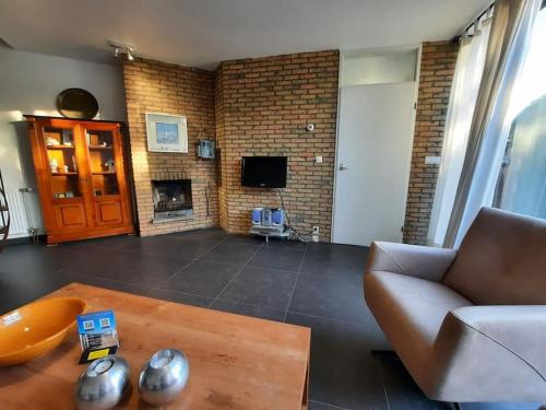 a living room with a couch and a fireplace at Zouterik 33* in Nieuwvliet