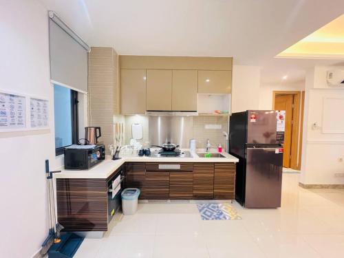 a kitchen with a stainless steel refrigerator and cabinets at R&F PRINCESS COVE at ANJU in Johor Bahru