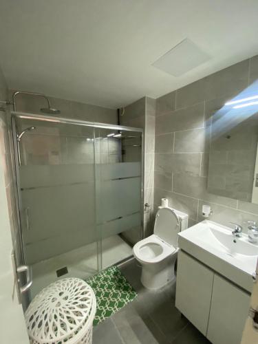 a bathroom with a shower and a toilet and a sink at Casa Greta in Costa de Antigua