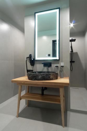 a mirror sitting on top of a wooden table at SAVOIE Apartments Bukovel in Bukovel