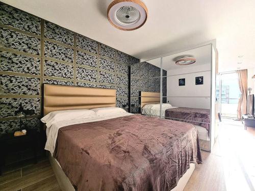 a bedroom with a large bed and a wall at Un pisito en Maspalomas in Maspalomas