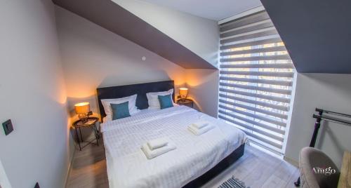 Postel nebo postele na pokoji v ubytování Maxim Apartments