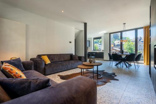 a living room with a couch and a table at La Maison Noire in La Roche-en-Ardenne