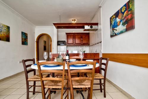 a dining room with a table and chairs and a kitchen at Unique Seaview Apartments and Penthouse in Central St Julians in St Julian's