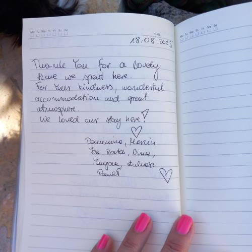 a hand holding a notebook withletters written in handwriting at Villa Frida in Sutomišćica