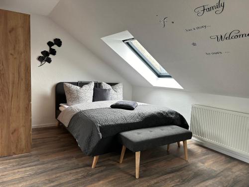 a bedroom with a bed and a skylight at Ferienwohnung Zeitz - Weiße Elster Apartment in Zeitz