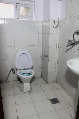a bathroom with a toilet and a sink at Hotel Happy Home or Mudkhu Durbar in Kathmandu
