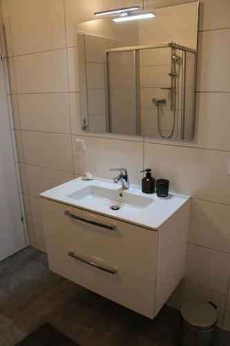 a bathroom with a sink and a mirror at Riverside Apartments in Linz