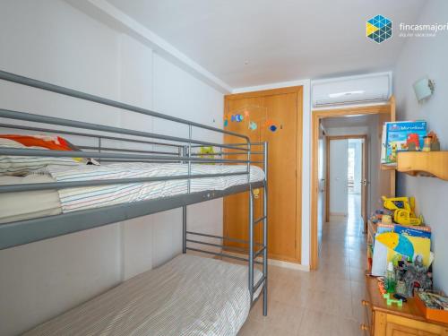 a bedroom with two bunk beds and a hallway at Apartamento Sky Blue in Colònia de Sant Jordi