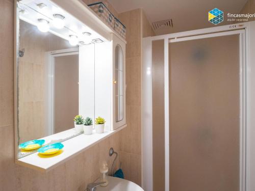 a bathroom with a sink and a mirror at Apartamento Sky Blue in Colònia de Sant Jordi