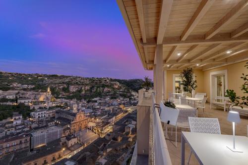 a balcony with a view of a city at night at Itria Modica in Modica