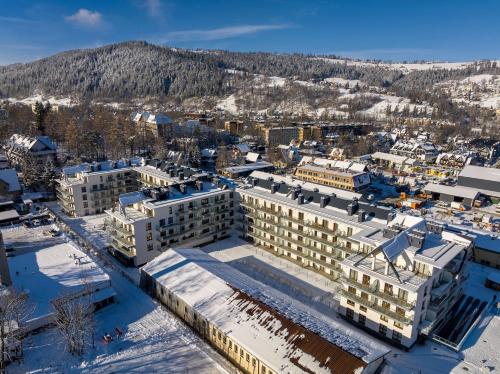an aerial view of a building in the snow at RentPlanet - Apartamenty Zakopiańskie in Zakopane