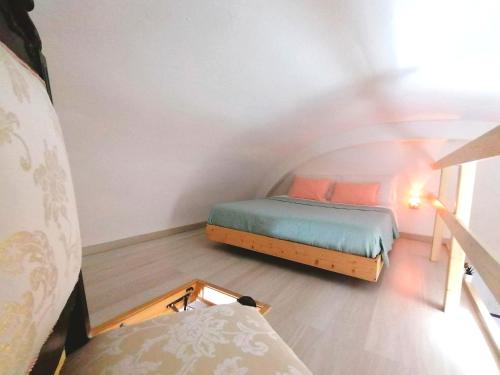 a small bedroom with two beds in a attic at DIMORA HELIANTHUS in Salandra